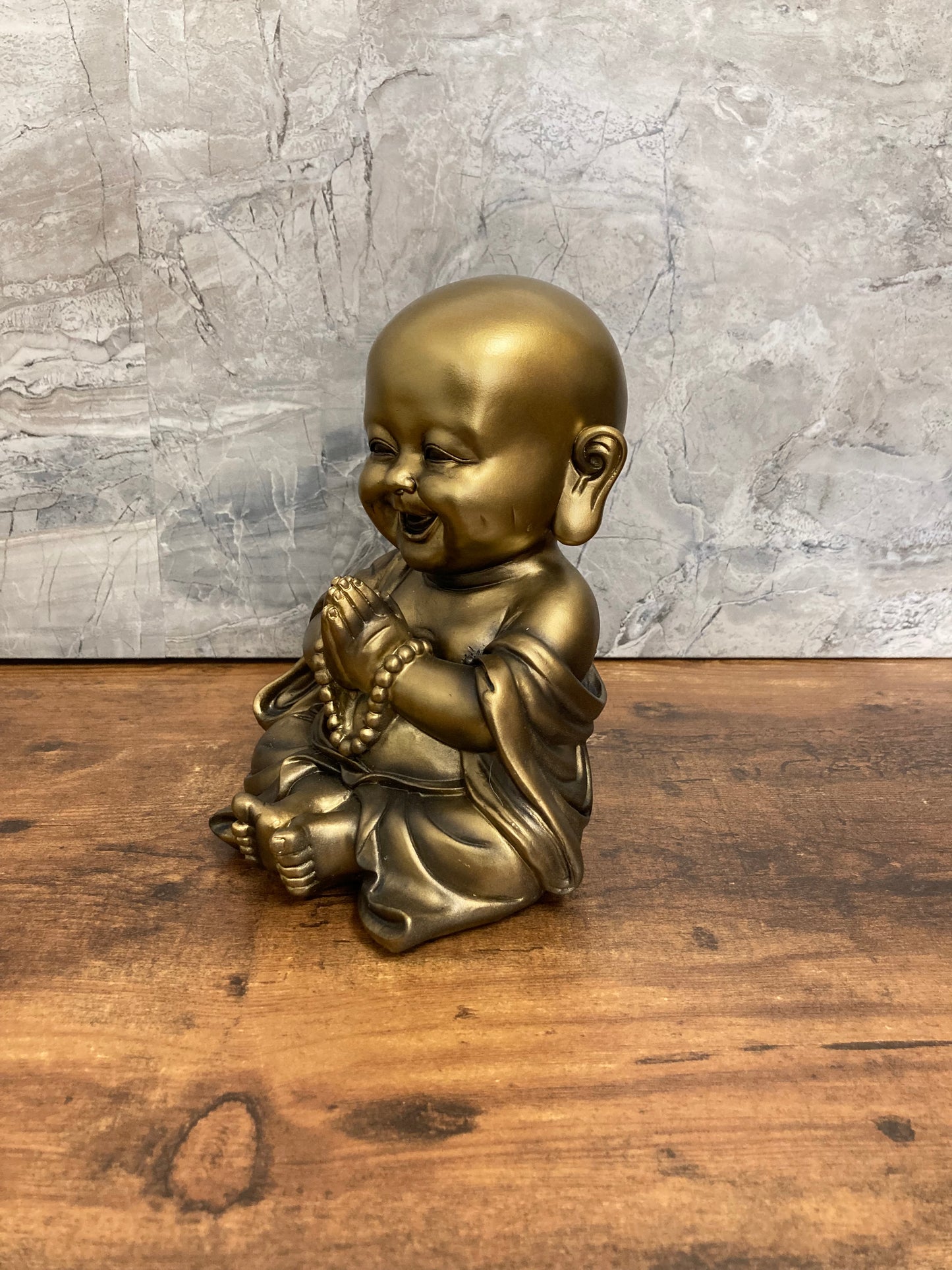 Golden Buddha Monk Baby statue made of ploy resin.